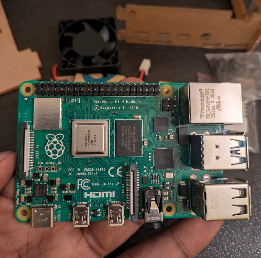 A Raspberry Pi 4 Model B held in a hand